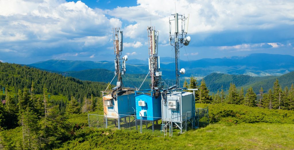 Growth of Cell Tower Companies Telecom towers and Digital and analog Television transmission tower on top of mountain.
